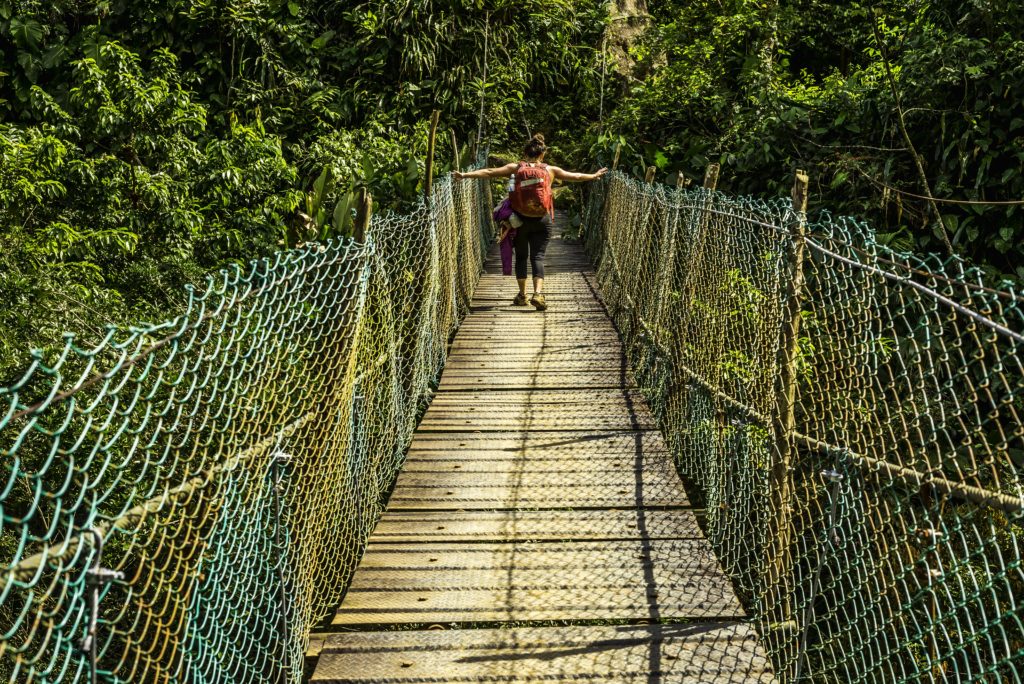 Crossing a river bridge along the hike